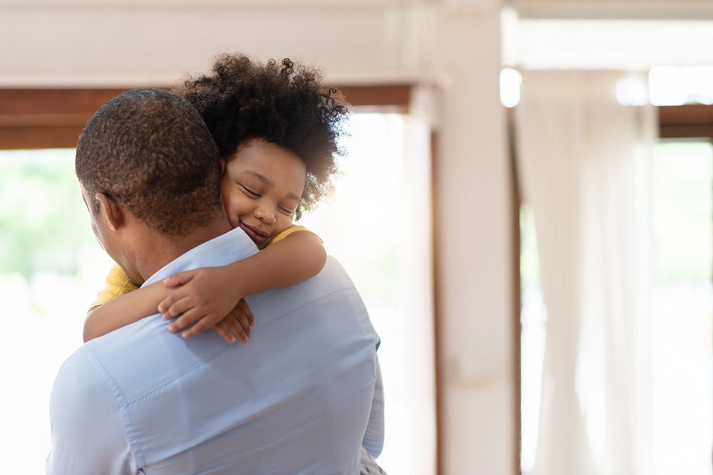 Father hugging child